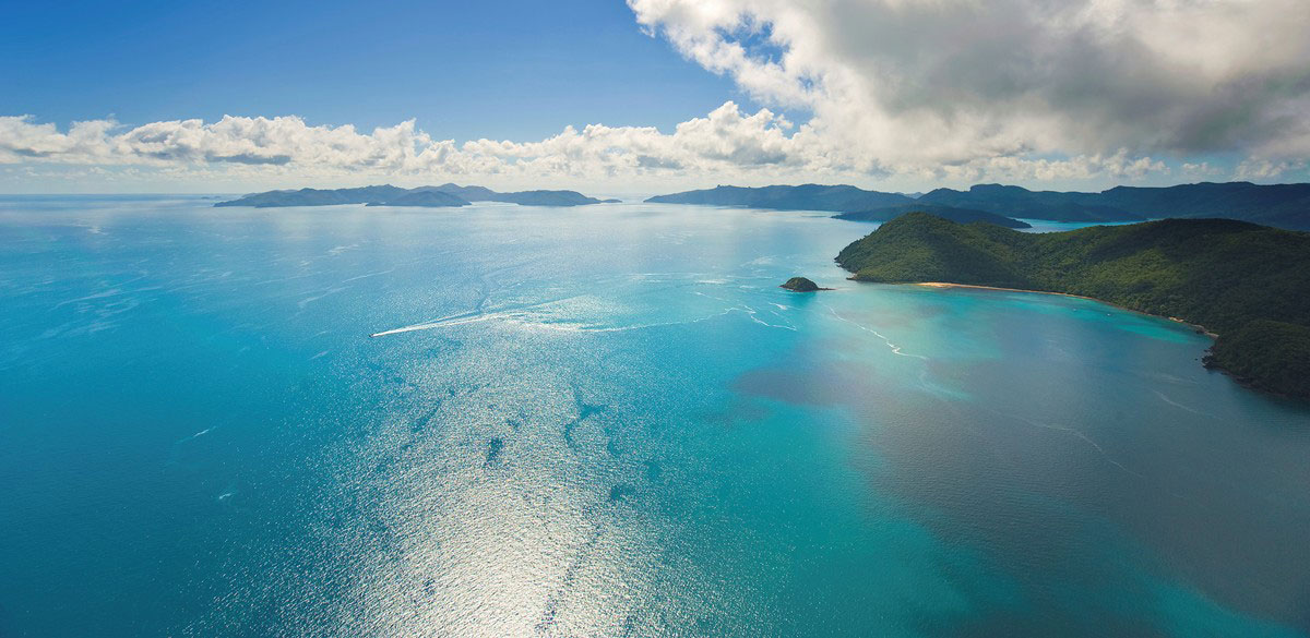 View over tropical turquoise waters and islands of the Whitsundays