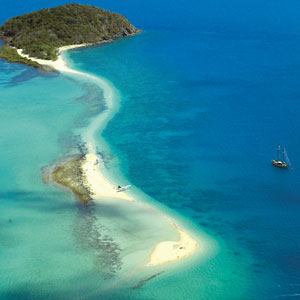 Aerial view of Langford Island in the Whitsundays with yacht offshore